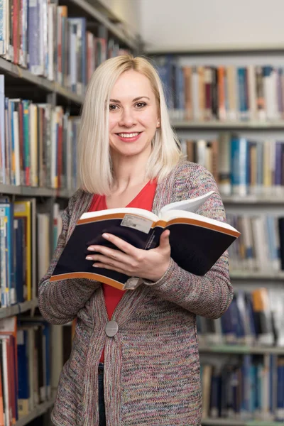 Student Reading from Book in a Library — Stock Photo, Image