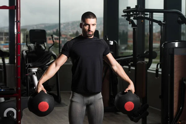 Bodybuilder Holding Ball Weights In Hand — Stock Photo, Image