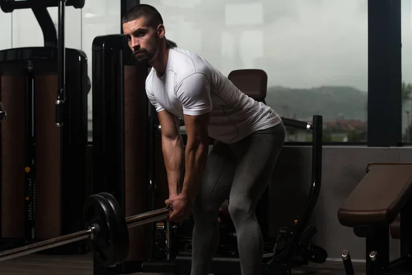 Muscular Man Exercising Back With Barbell — Stock Photo, Image