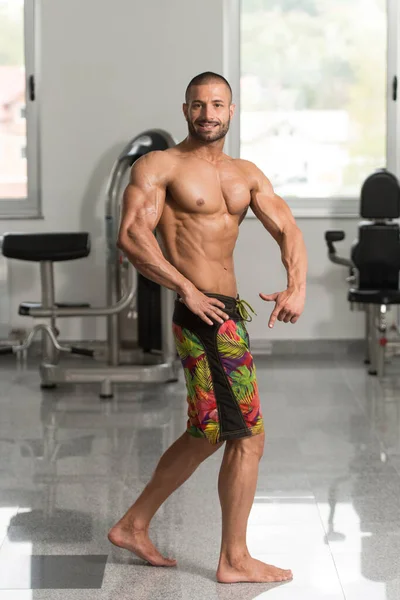 Healthy Young Man Flexing Muscles