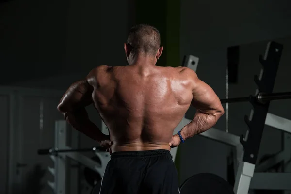 Muscular maduro homem flexing músculos no ginásio — Fotografia de Stock