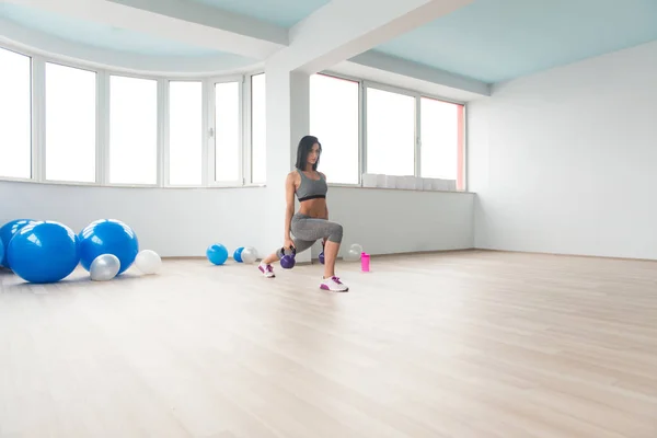 Jeune femme en bonne santé faisant l'exercice avec la cloche de bouilloire — Photo