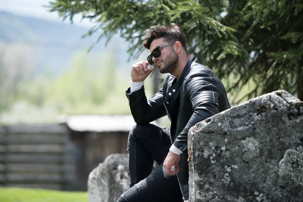 Man Sits Down Strong Outdoors in Nature Posing — Stock Photo, Image