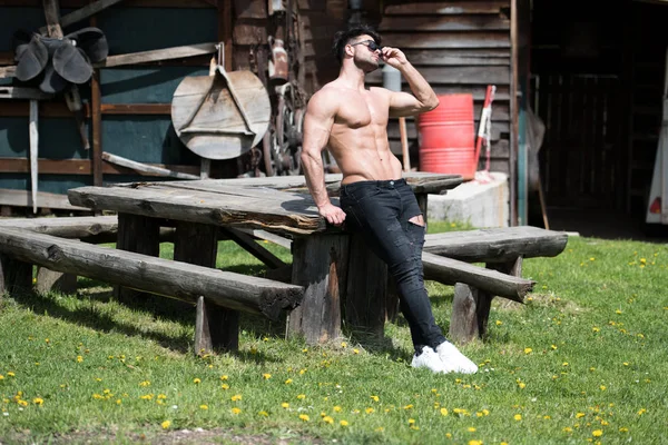 Model Flexing Muscles Outdoors in Nature — 스톡 사진