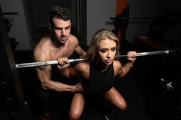 Woman With Personal Trainer At Barbell Squat — Stock Photo, Image