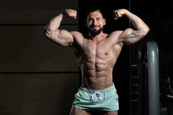 Bodybuilder Performing Rear Double Biceps Pose — Stock Photo, Image
