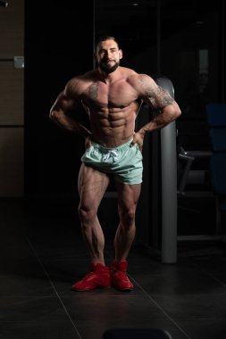 Yakışıklı kaslı adam içinde jimnastik salonu kas esneme