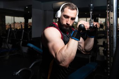 Kablosu ile Triceps için ağır egzersiz yaparak vücut geliştirmeci