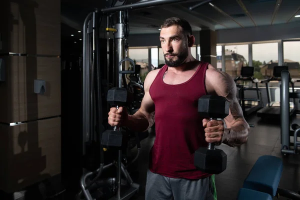 Biceps Exercise With Dumbbells In A Gym — Stock Photo, Image