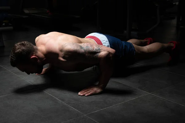 Hombre haciendo prensa sube en el gimnasio — Foto de Stock