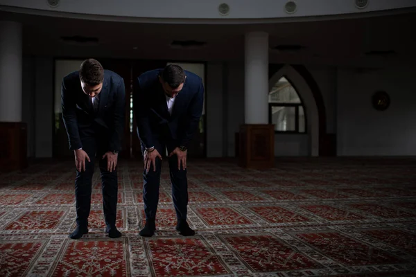 Two Attractive Man Making Traditional Prayer to God Allah in the Mosque