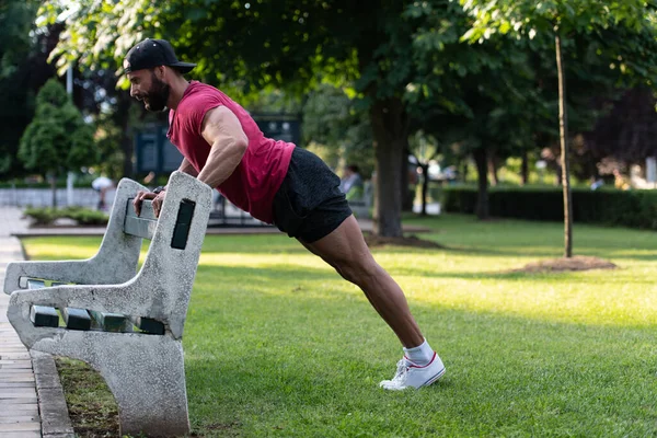 Junger Mann Roten Shirt Macht Liegestütze Auf Einer Hölzernen Parkbank — Stockfoto