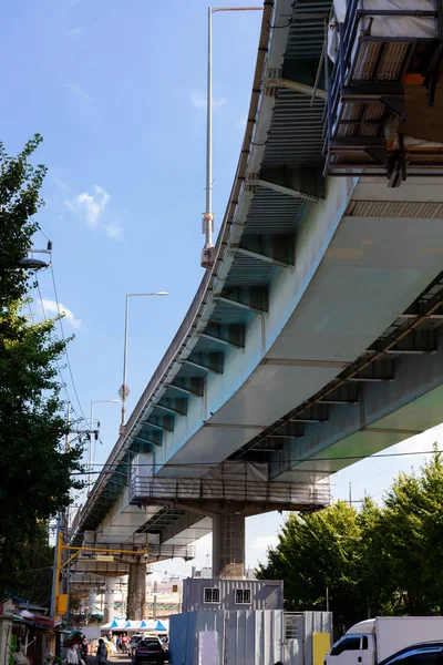 Vista inferior de paso elevado. Autopista sobre una zona residencial. Infraestructura de hormigón armado. Estilo de vida urbano . — Foto de Stock