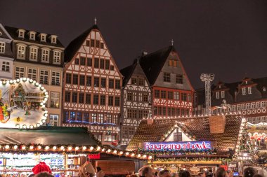 Frankfurt am main, Germany - November 25, 2019: Christmas atmosphere in the city center near Romer. People walk, drink mulled wine and buy gifts