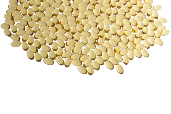 Softgels of Omega-3 on whight background with copy space. Fish oil on a white background. Yellow capsules with medicine. Medical medicament of polyunsaturated fatty acids. Macro top view — Stock Photo, Image