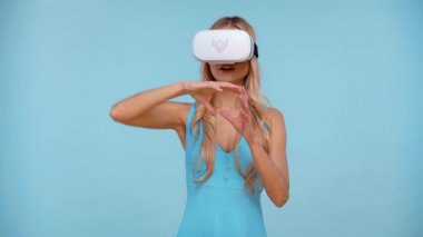 woman with virtual reality headset isolated on blue