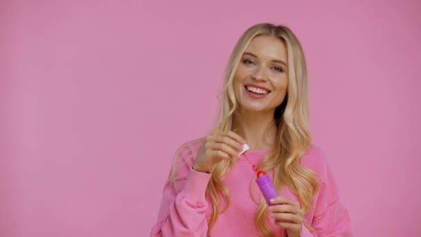 Smiling Woman Blowing Soap Bubbles Isolated Pink — Stock Video