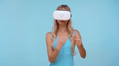 woman with virtual reality headset isolated on blue