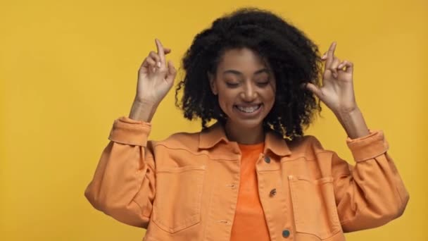 Glimlachende Afrikaan Amerikaanse Vrouw Tonen Gekruiste Vingers Geïsoleerd Geel — Stockvideo