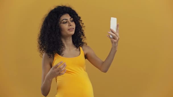 Smiling Racial Pregnant Woman Taking Selfie Isolated Dark Yellow — Stock Video