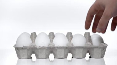 cropped view of man taking raw eggs on white 
