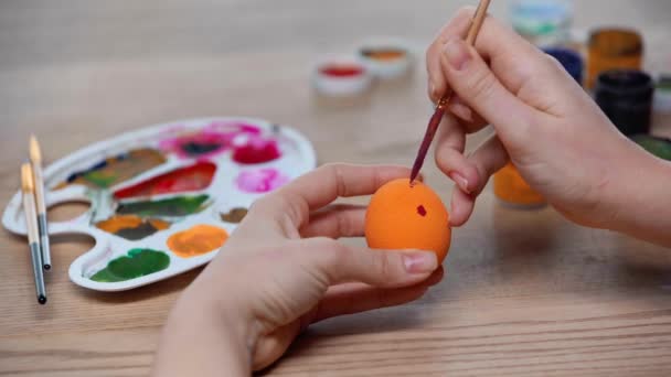 女人画橙色复活节彩蛋的剪影 — 图库视频影像