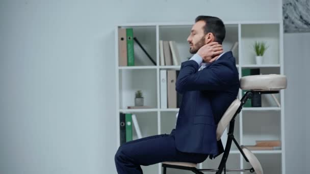 Back View Businessman Sitting Massage Chair Touching Painful Neck — Stock Video