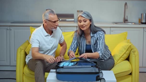 Asian Woman Packing Suitcase Senior Husband — Stock Video