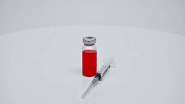 Coronavirus Red Vaccine Syringe Lab White Surface — Stock Video