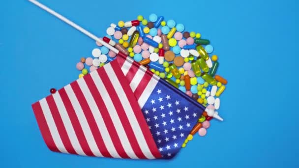 Top View American Flag Pills Spinning Blue Background — Stock Video