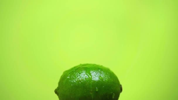Drops Falling Whole Ripe Lime Isolated Green Slow Motion — Stock Video