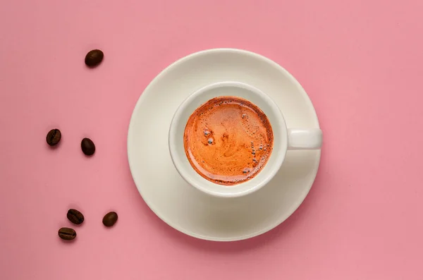 Puesta plana creativa de taza de café blanco y algunos granos de café sobre fondo rosado milenario. Estilo mínimo. Pero el café es el primer concepto. Copiar espacio. Plantilla para blog femenino, redes sociales, redes — Foto de Stock