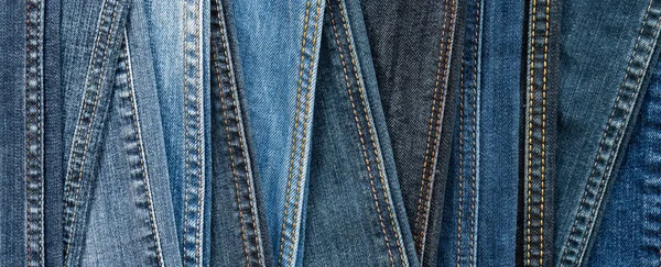 Denim background. Blue jeans seams of different shades and textures. Banner — Stock Photo, Image