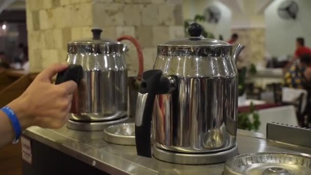 People Take Hot Shiny Metal Teapots Black Handle Restaurant — Stock Video