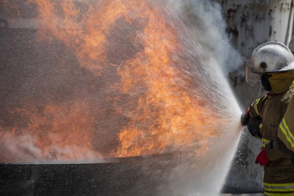 Firefighters Extinguishing House Fire Stock Picture