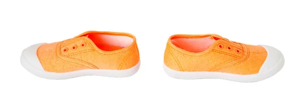 Baby meisje oranje stof sneakers. — Stockfoto