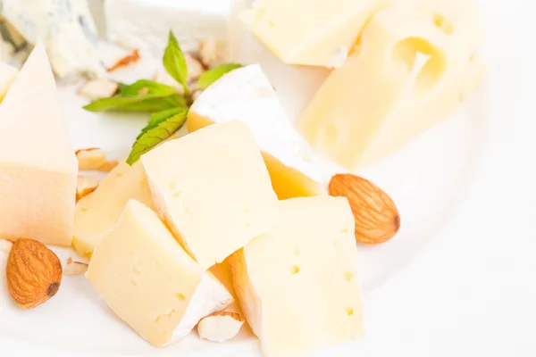 Assorted cheese platter with almonds closeup. — Stock Photo, Image