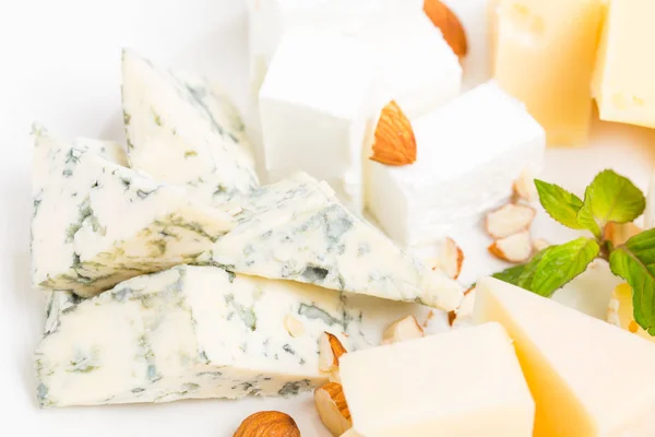 Assorted cheese platter with almonds closeup. — Stock Photo, Image