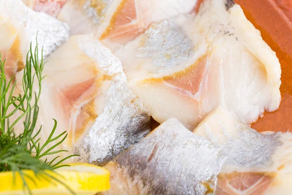 Sliced herring and dill on plate. — Stock Photo, Image
