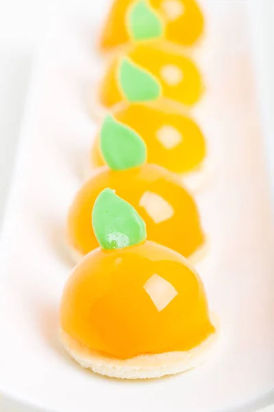 Delicious orange glazed cakes. — Stock Photo, Image