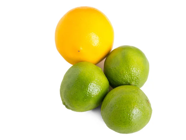 Closeup of fresh limes and orange. — Stock Photo, Image