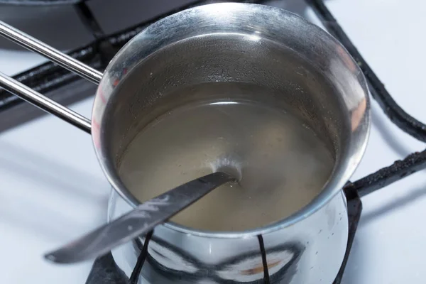 Melted gelatin in metal pot. — Stock Photo, Image