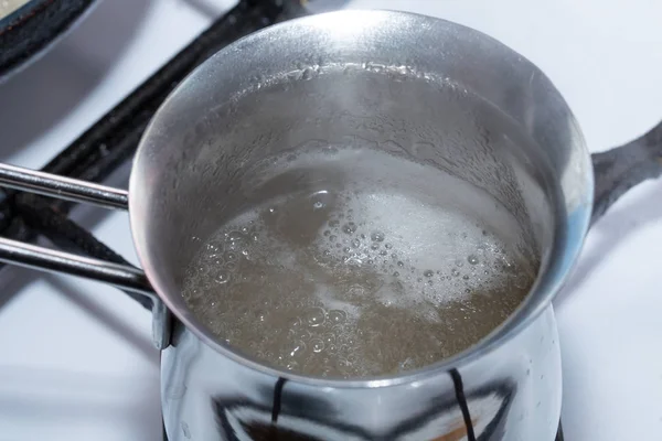 Melted gelatin in metal pot. — Stock Photo, Image