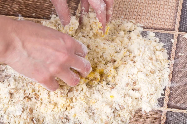 Male hands making dough with walnuts. — Stock Photo, Image