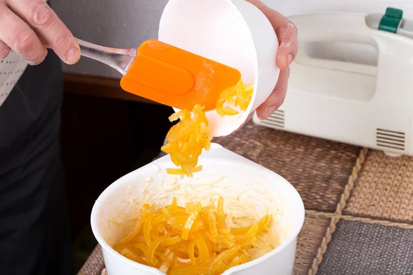 Mixing citrus peels with cake dough. — Stock Photo, Image