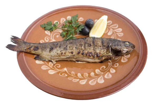 Baked carp on a clay plate. — Stock Photo, Image