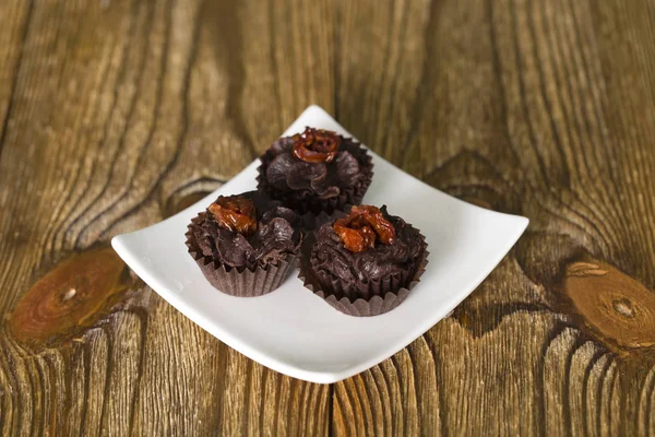 Set of chocolate candies with a fondant and dried tomato. — Stock Photo, Image