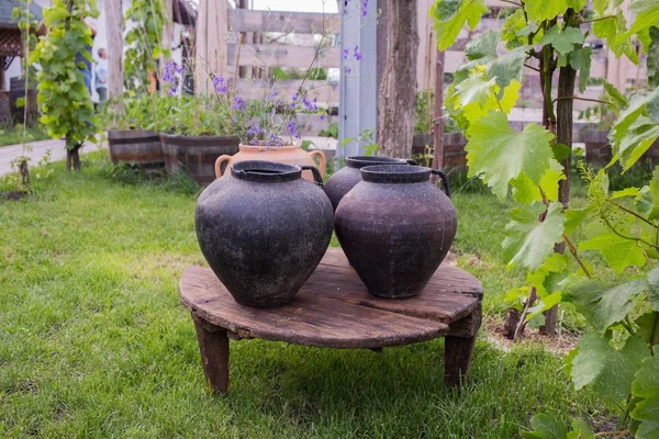 Three very old crocks on the wooden table. — Stock Photo, Image