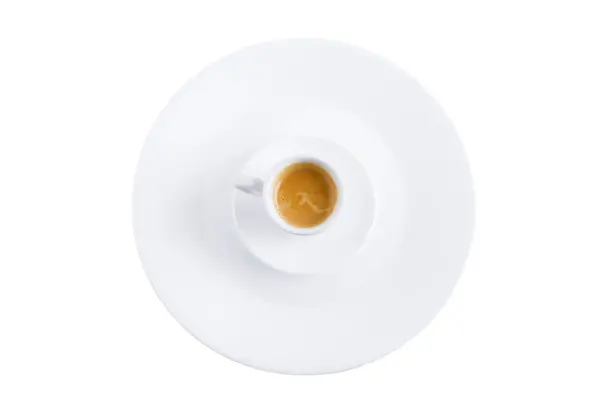 Uma xícara de café em um pires e um prato . — Fotografia de Stock