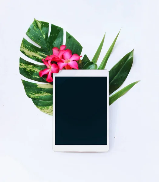 Tablet with tropical flowers on a white background — Stock Photo, Image